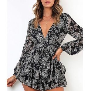 Black floral print ruffle romper.